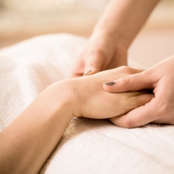 Close-up of female beautician doing hand massage